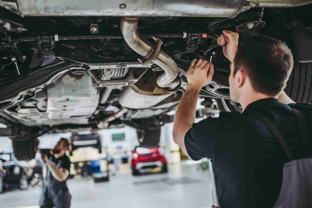 Mechanic working under a car